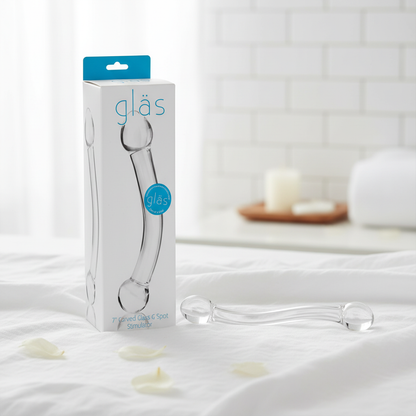 Glas curved dildo with packaging on white linen
