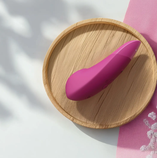 Pink object on a wooden plate with a pink cloth in the background